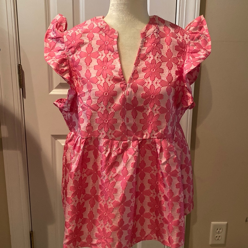 Pink and white flutter sleeve blouse.
